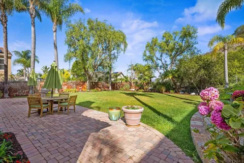 a view of a chair and tables in the backyard
