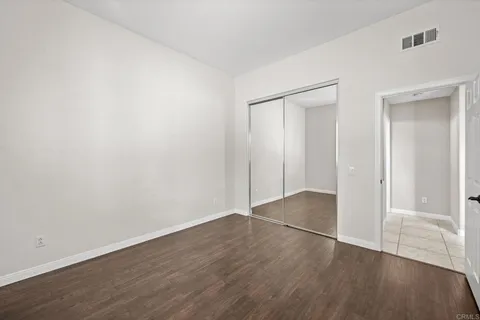 an empty room with wooden floor