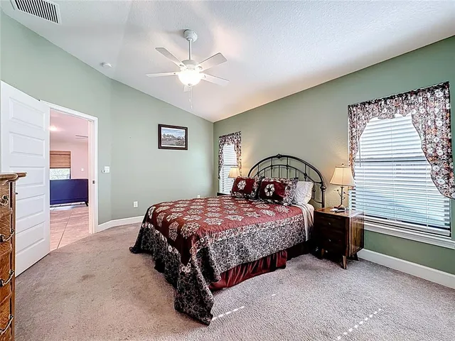 a bedroom with a bed and a mirror