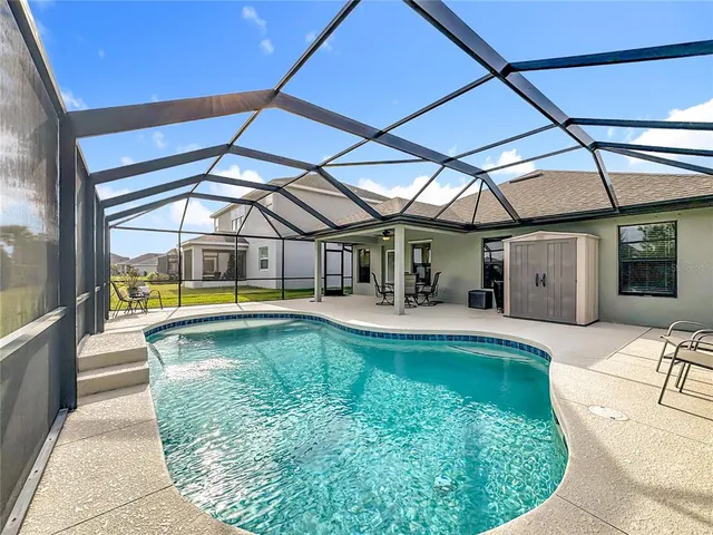 a view of a swimming pool with a patio