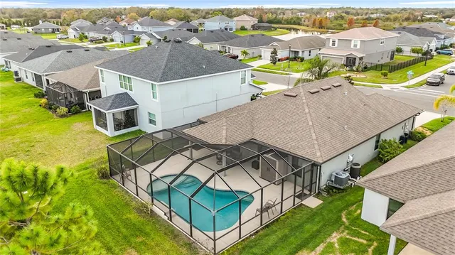 an aerial view of residential houses with outdoor space