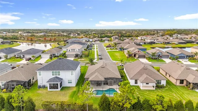 an aerial view of residential houses with outdoor space