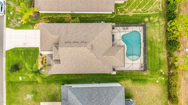 an aerial view of a house with a swimming pool