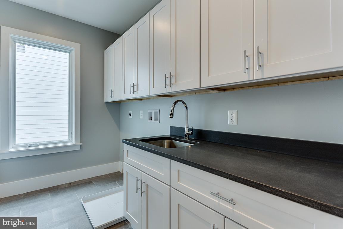 8826 Ridge Road Bethesda, MD 20817 - Photo 24 of 45 Laundry room with lots of cabinets