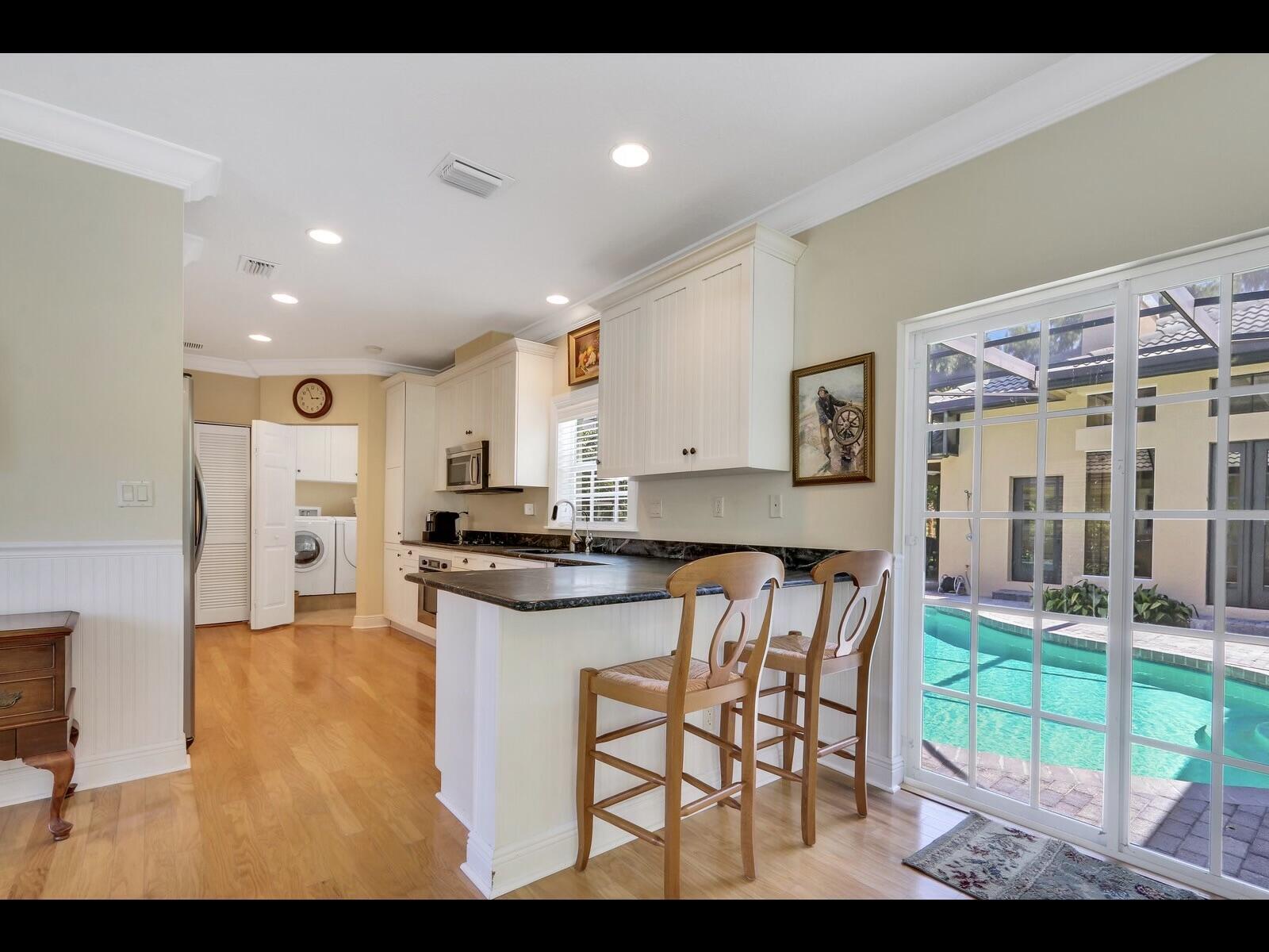 1856 Southeast Colony Way Jupiter, FL 33478 - Photo 3 of 10 a kitchen with a table and chairs