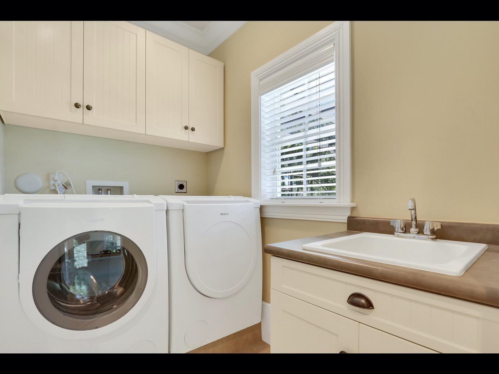 1856 Southeast Colony Way Jupiter, FL 33478 - Photo 5 of 10 a bathroom with a sink a washer and dryer
