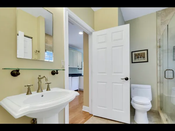 a bathroom with a sink toilet and shower