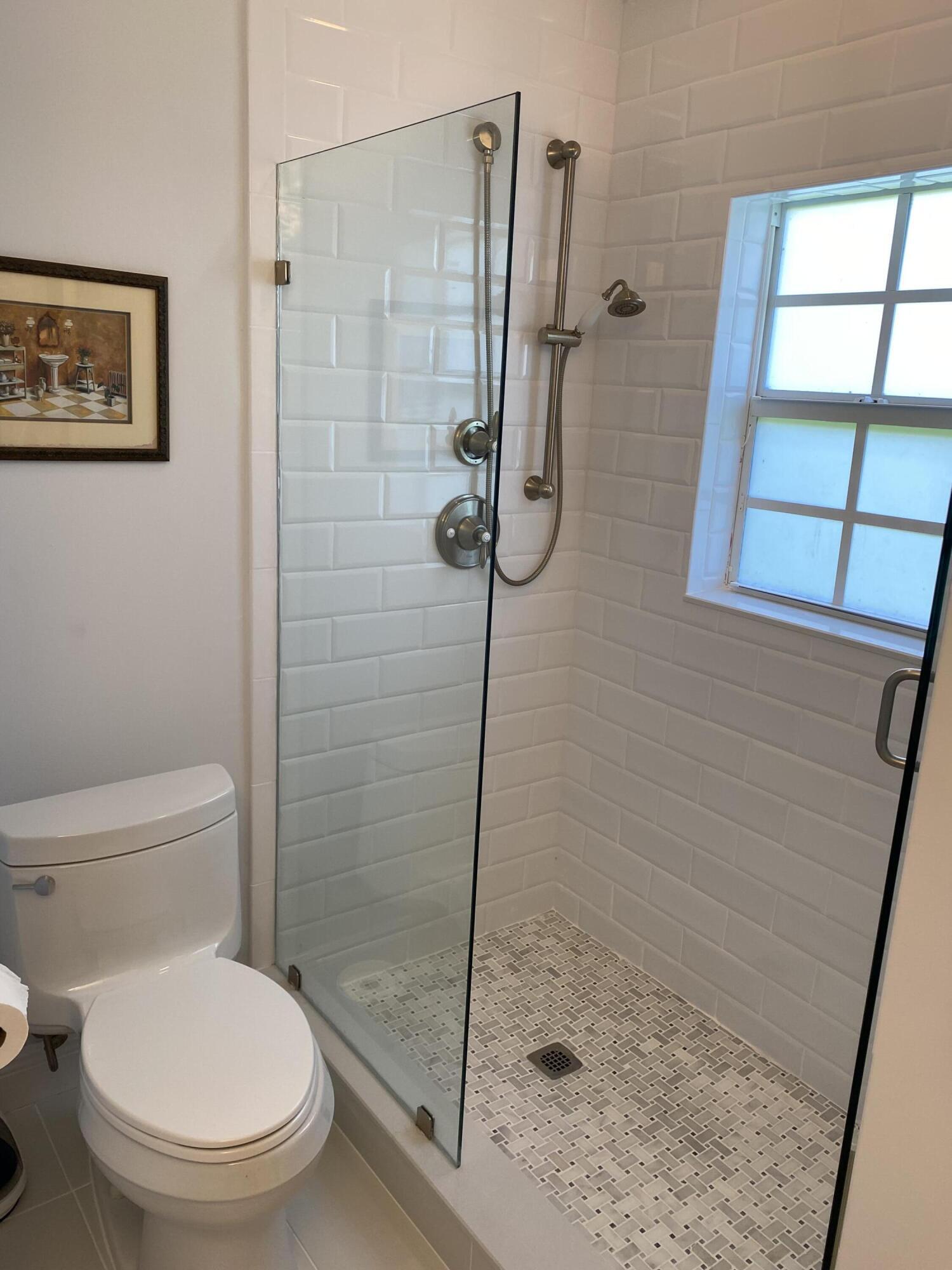 1856 Southeast Colony Way Jupiter, FL 33478 - Photo 9 of 10 a white toilet sitting next to a shower