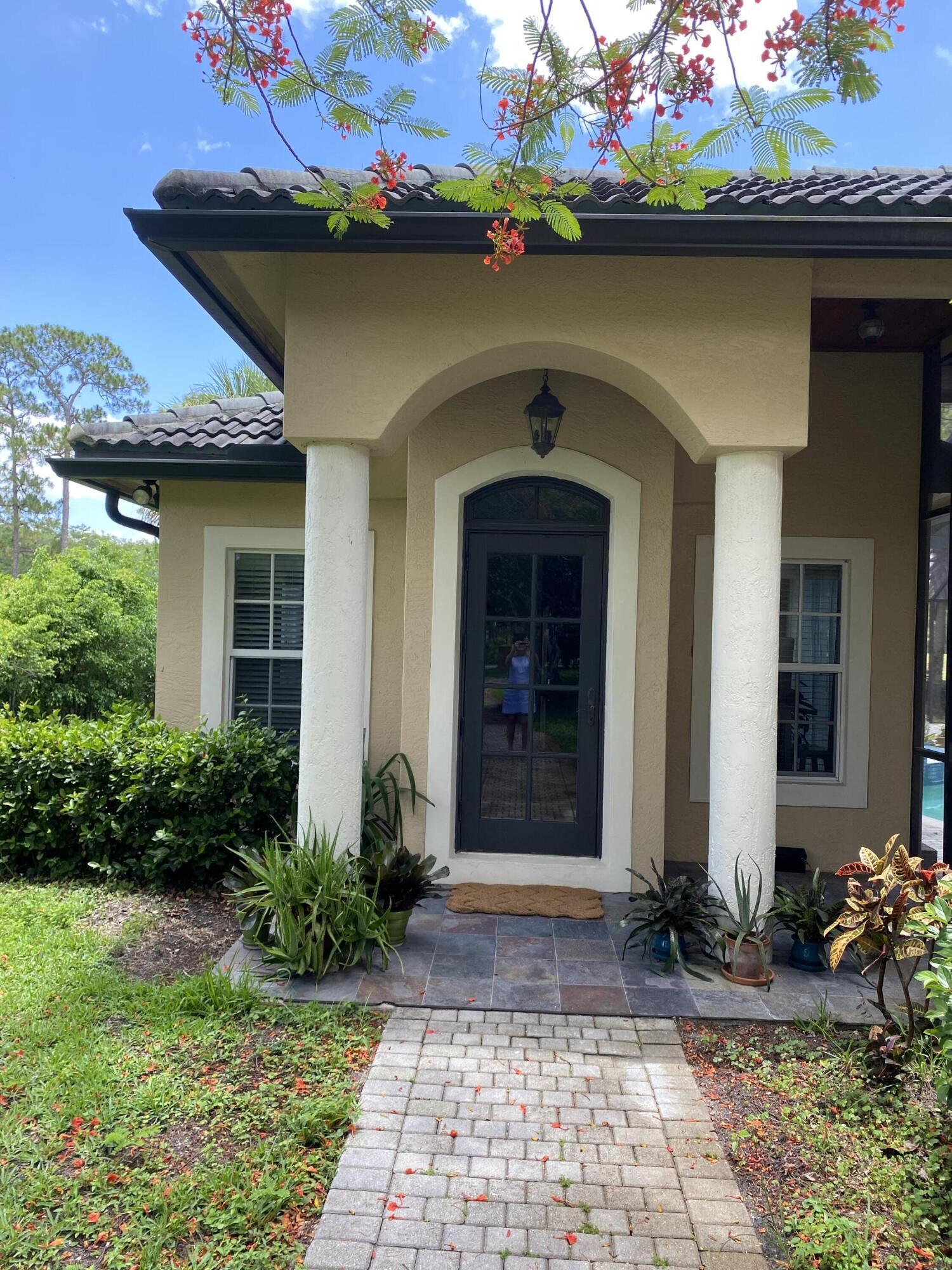 1856 Southeast Colony Way Jupiter, FL 33478 - Photo 10 of 10 a front view of a house with a garden