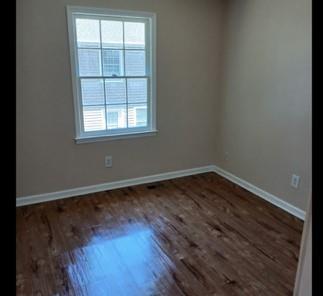 522 Jackson Street Rockmart, GA 30153 - Photo 14 of 27 an empty room with wooden floor and windows