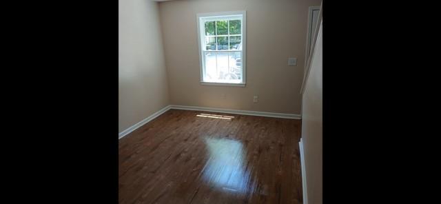 522 Jackson Street Rockmart, GA 30153 - Photo 2 of 27 a view of an empty room with wooden floor and a window