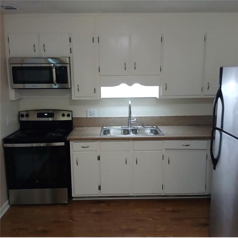 522 Jackson Street Rockmart, GA 30153 - Photo 22 of 27 a kitchen with granite countertop white cabinets stainless steel appliances and sink