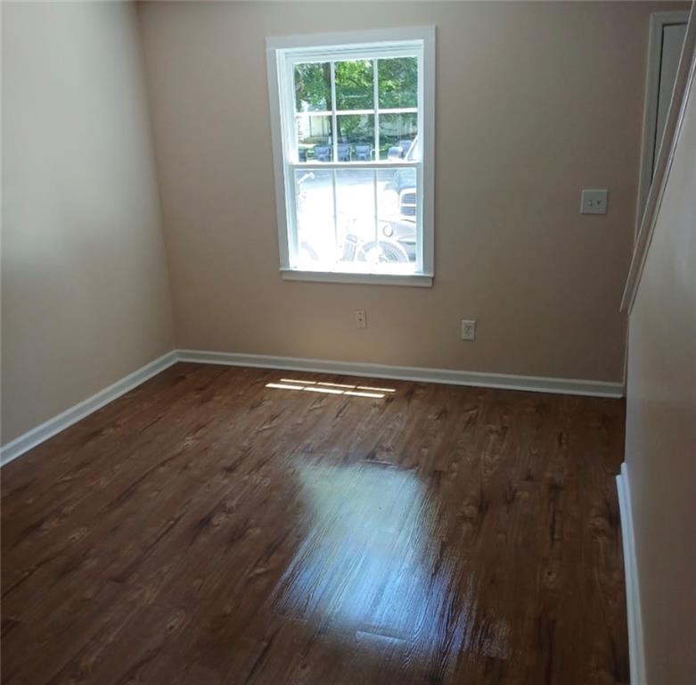 522 Jackson Street Rockmart, GA 30153 - Photo 23 of 27 an empty room with wooden floor and windows