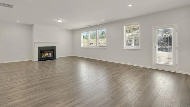 a kitchen with a sink a stove a refrigerator and white cabinets
