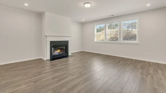 a view of kitchen with granite countertop cabinets and wooden floor