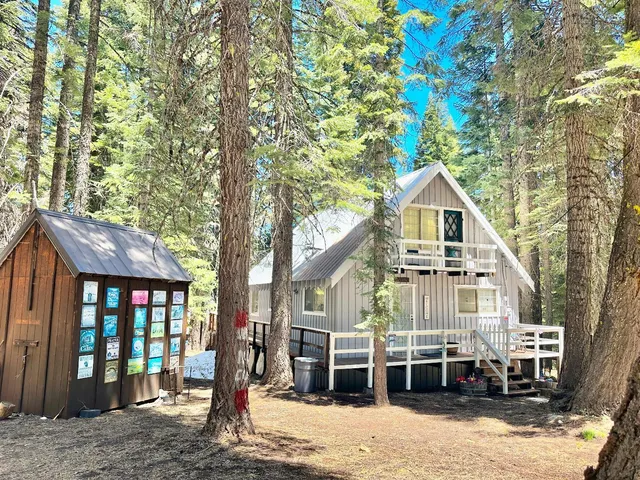 a front view of a house with a yard and balcony