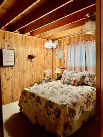 a bedroom with a bed and a mirror