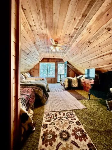 a bedroom with furniture and a flat tv screen