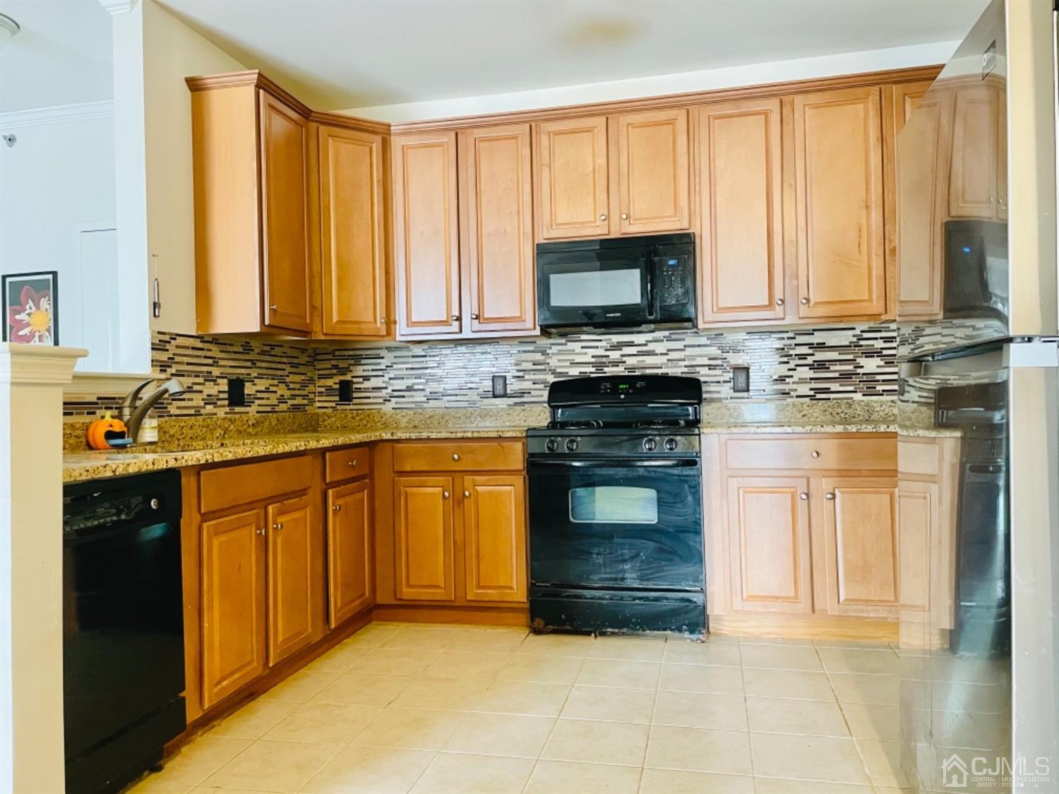 2332 Edward Stec Boulevard Edison, NJ 08837 - Photo 6 of 19 a kitchen with stainless steel appliances granite countertop a stove a sink and a microwave