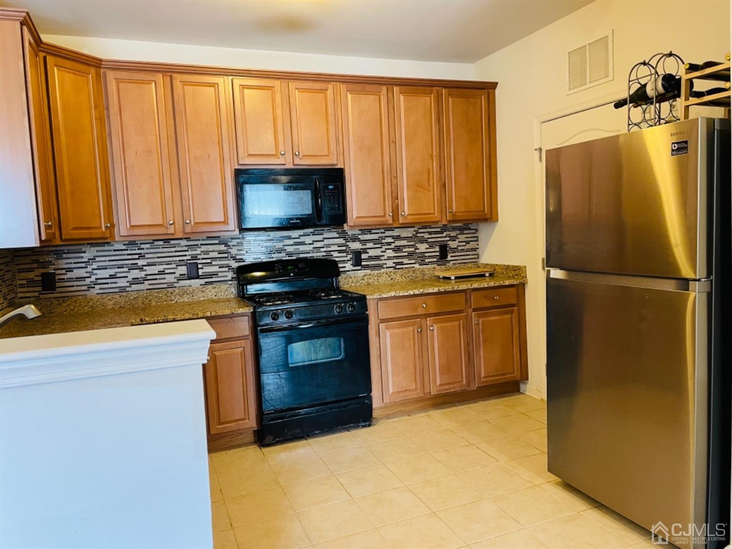 2332 Edward Stec Boulevard Edison, NJ 08837 - Photo 7 of 19 a kitchen with a stove a sink and a refrigerator