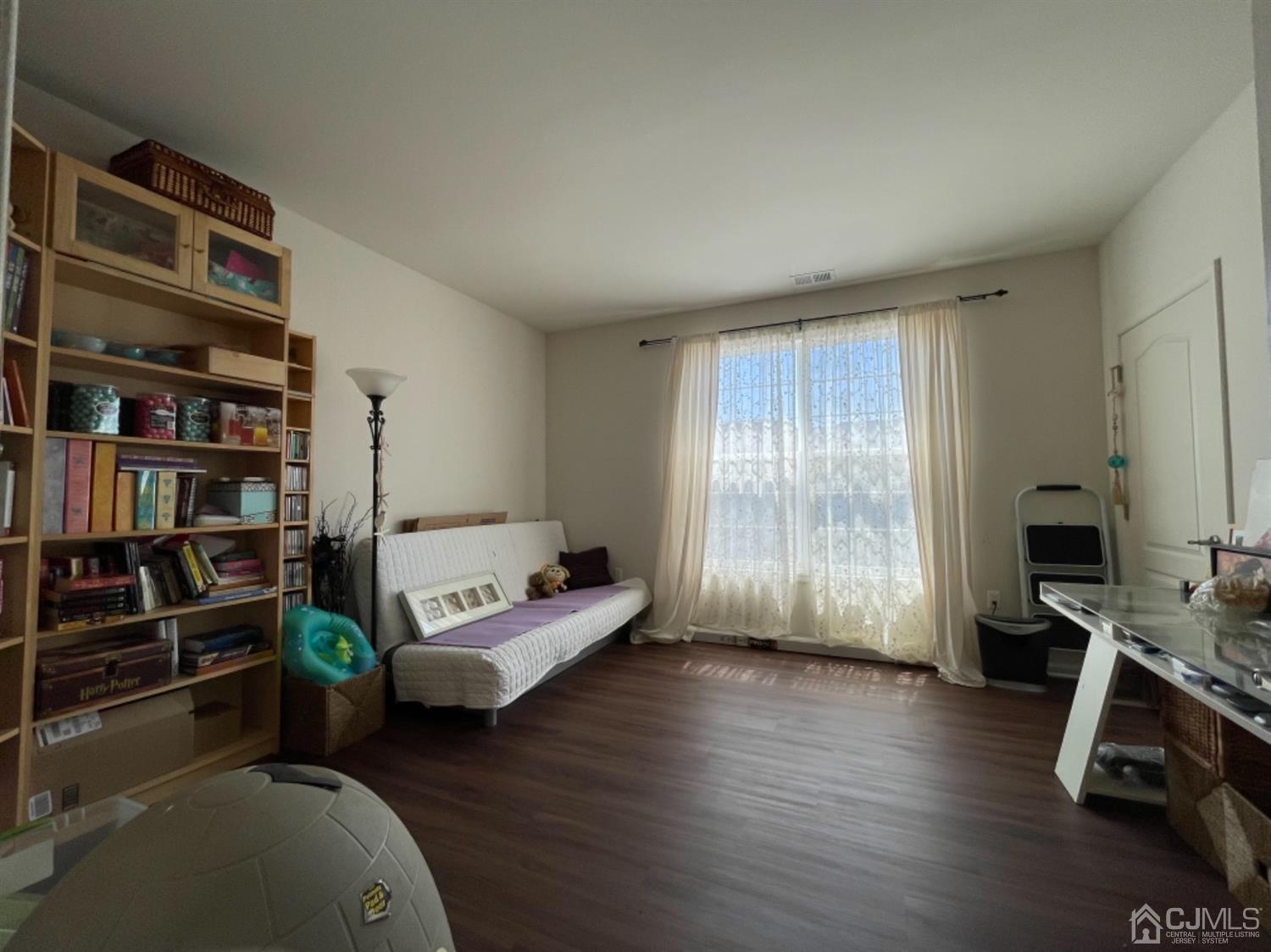 2332 Edward Stec Boulevard Edison, NJ 08837 - Photo 8 of 19 a living room with furniture a bookshelf and a window