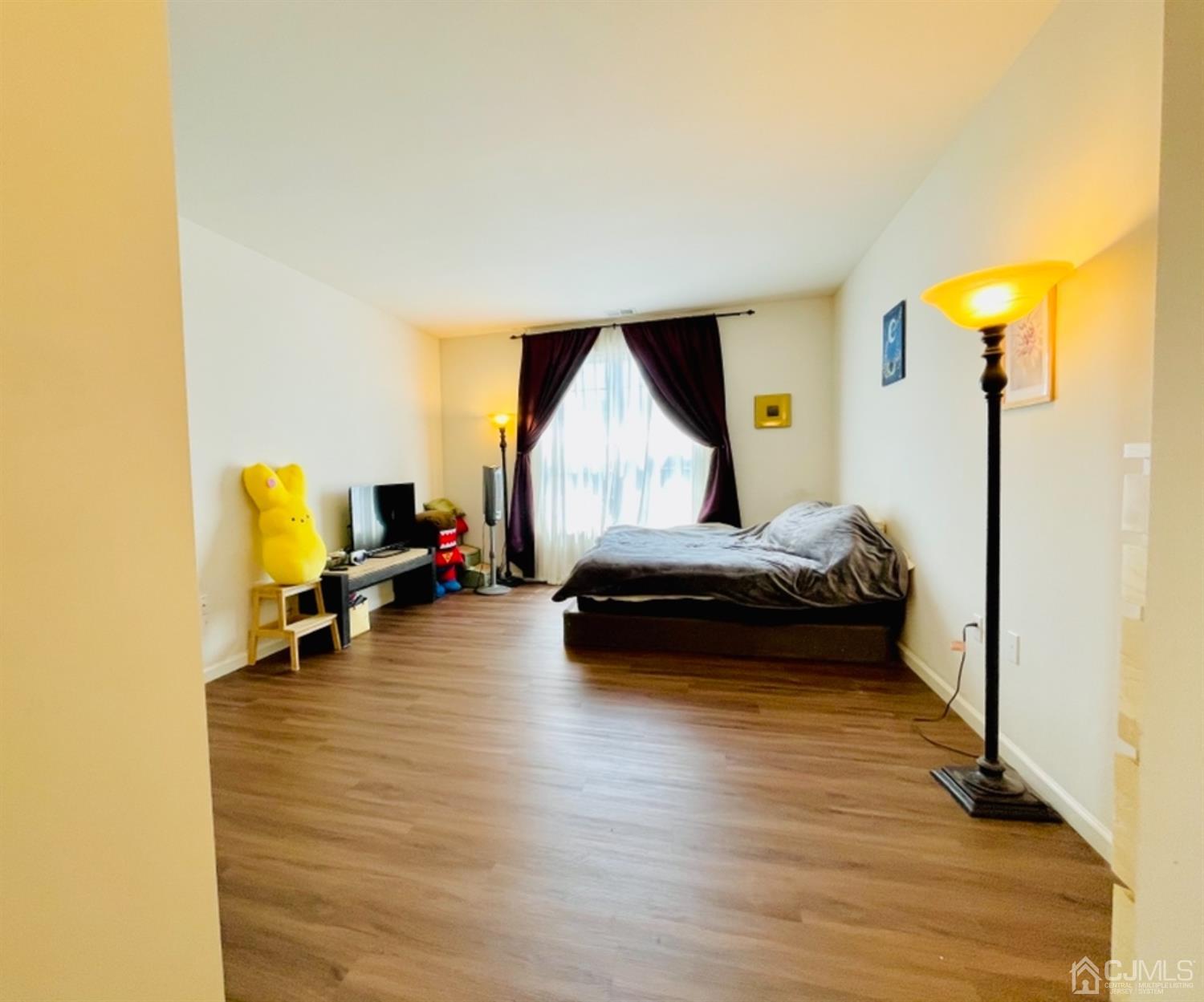 2332 Edward Stec Boulevard Edison, NJ 08837 - Photo 10 of 19 a bedroom with a bed and wooden floor