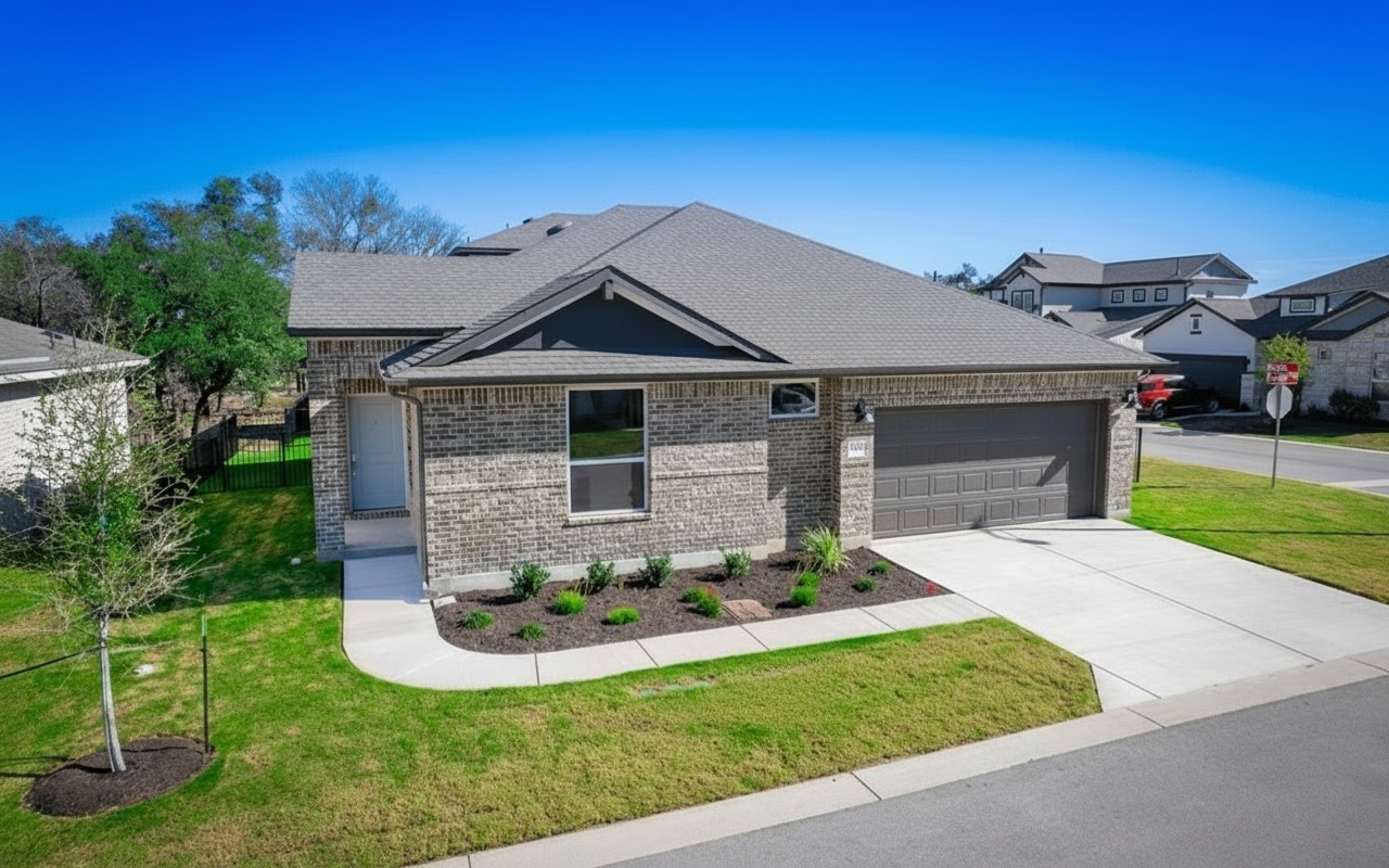 a front view of a house with a yard and garage