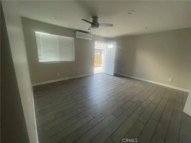 a kitchen with a sink cabinets and wooden floor