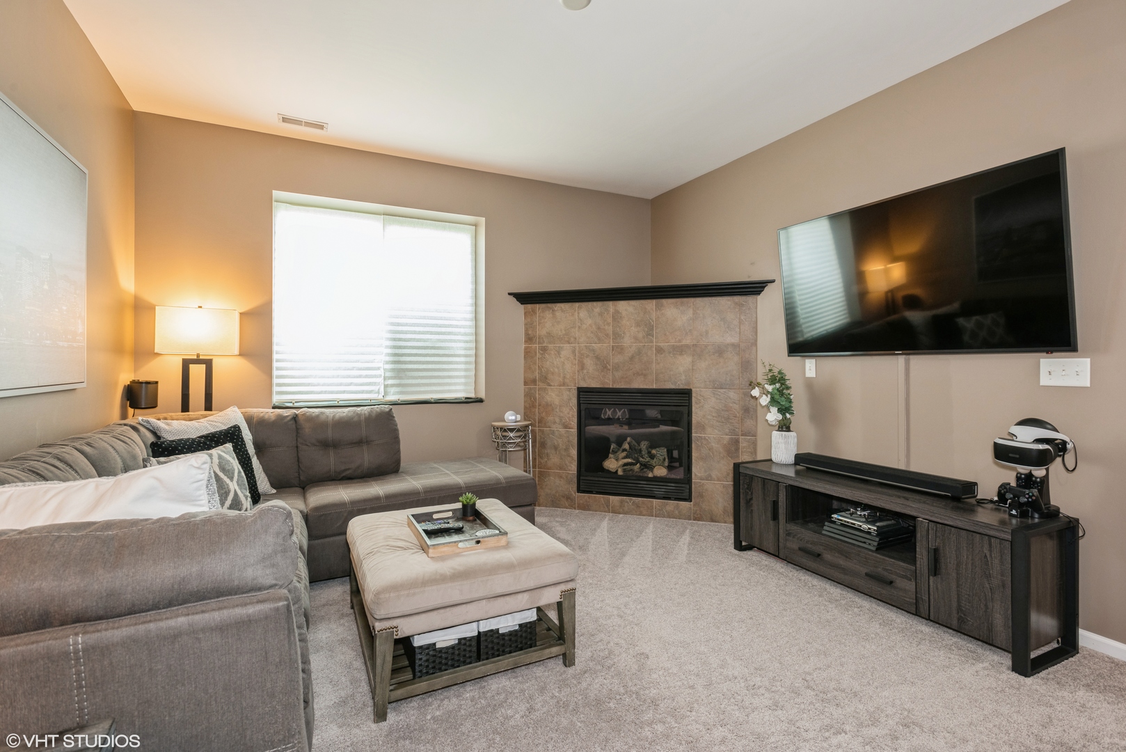 939 Oak Ridge Boulevard Elgin, IL 60120 - Photo 14 of 24 a living room with furniture a flat screen tv and a fireplace
