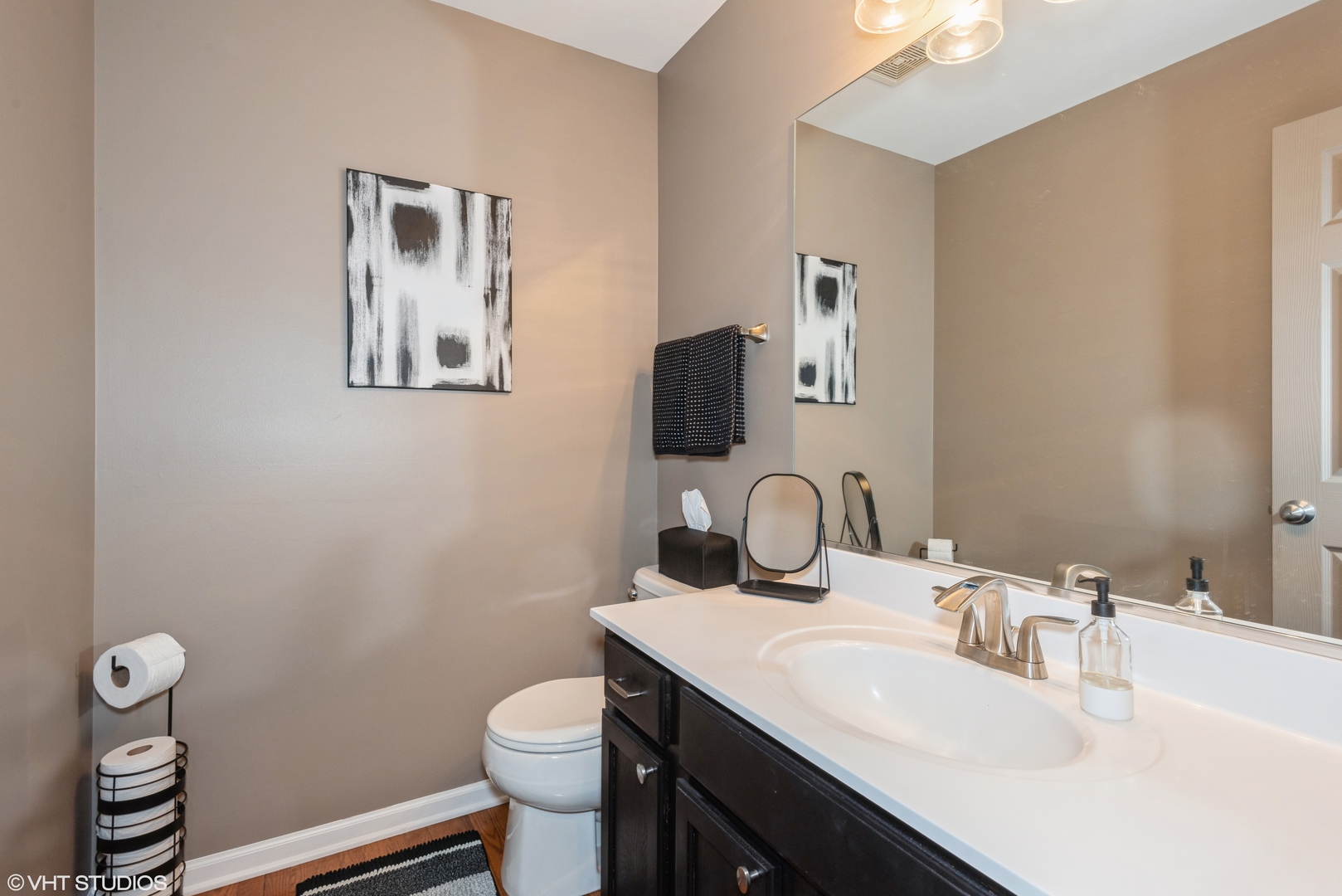 939 Oak Ridge Boulevard Elgin, IL 60120 - Photo 8 of 24 a bathroom with a toilet sink vanity and mirror