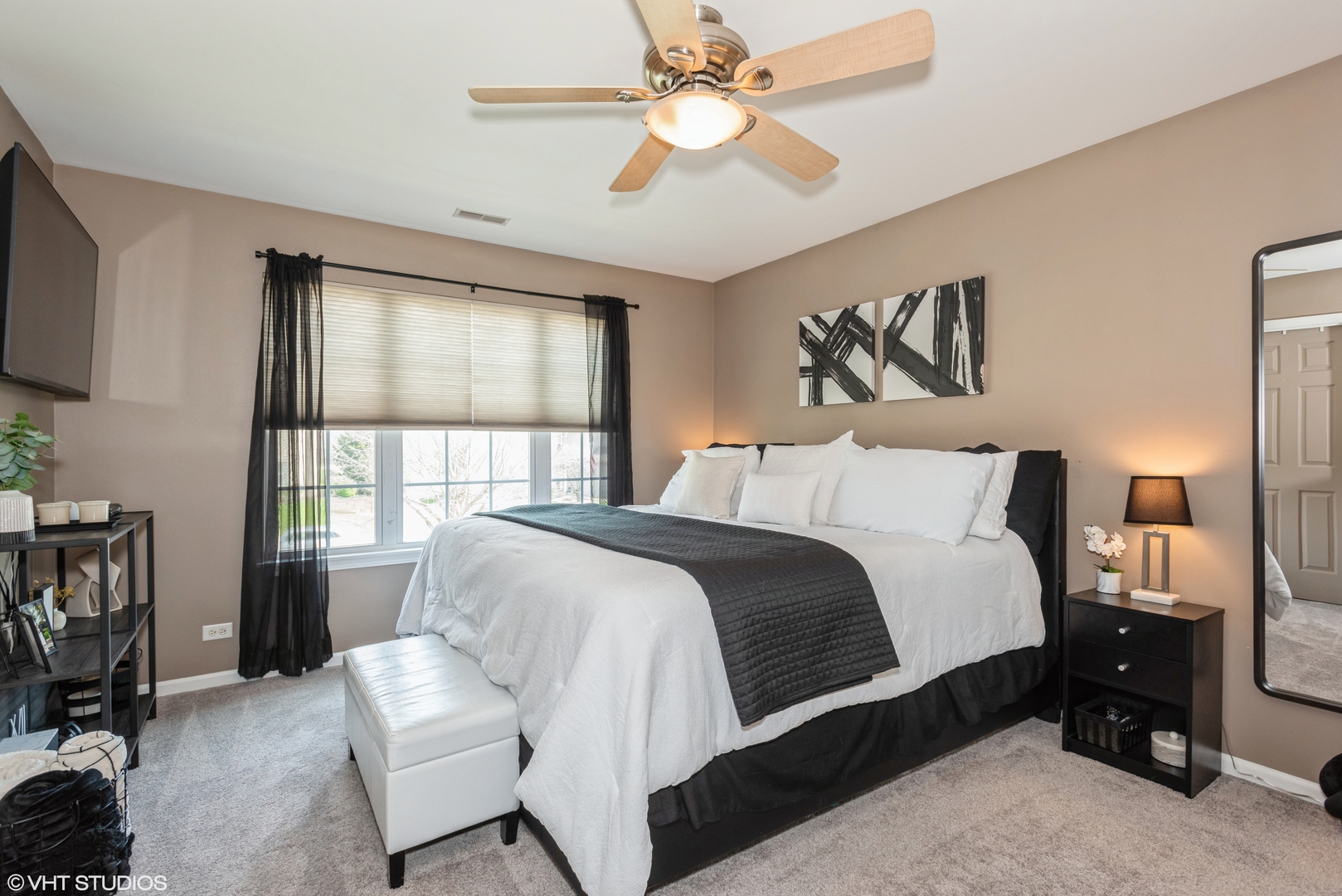 939 Oak Ridge Boulevard Elgin, IL 60120 - Photo 9 of 24 a bedroom with a bed and a chandelier