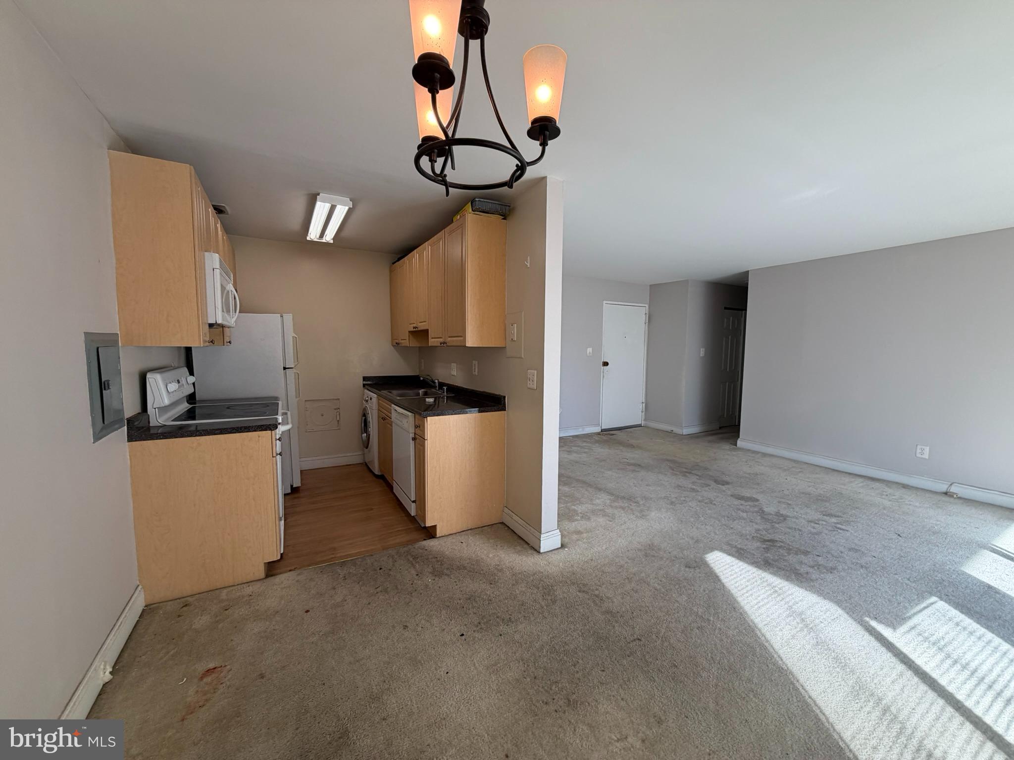 1009 Chillum Road, Unit 206 Hyattsville, MD 20782 - Photo 11 of 25 a kitchen with stainless steel appliances granite countertop a sink a stove a refrigerator a washer dryer and a dining table