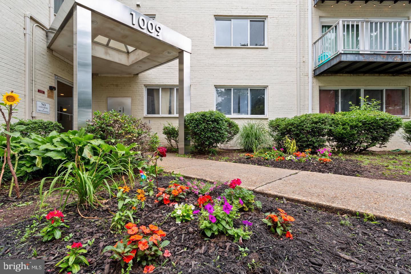 1009 Chillum Road, Unit 206 Hyattsville, MD 20782 - Photo 3 of 25 a front view of a house with a yard and fountain