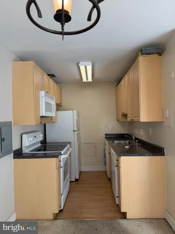 a kitchen with stainless steel appliances granite countertop a sink a stove and a microwave