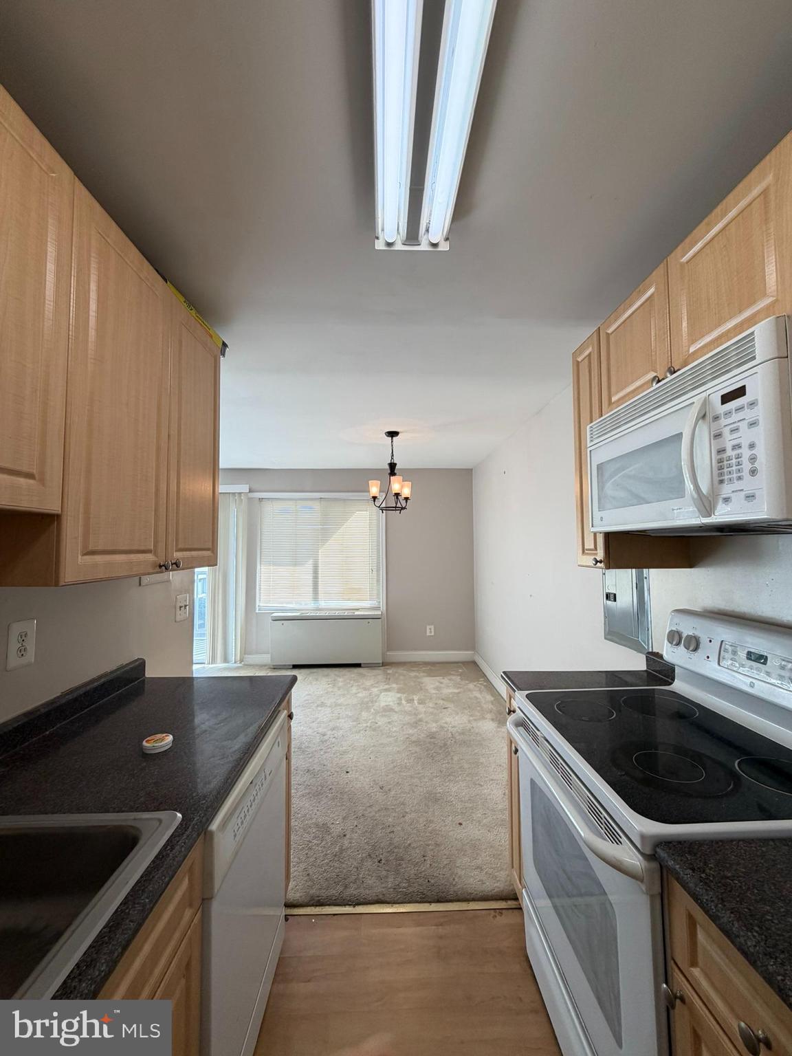 1009 Chillum Road, Unit 206 Hyattsville, MD 20782 - Photo 10 of 25 a kitchen with granite countertop a sink and a stove top oven