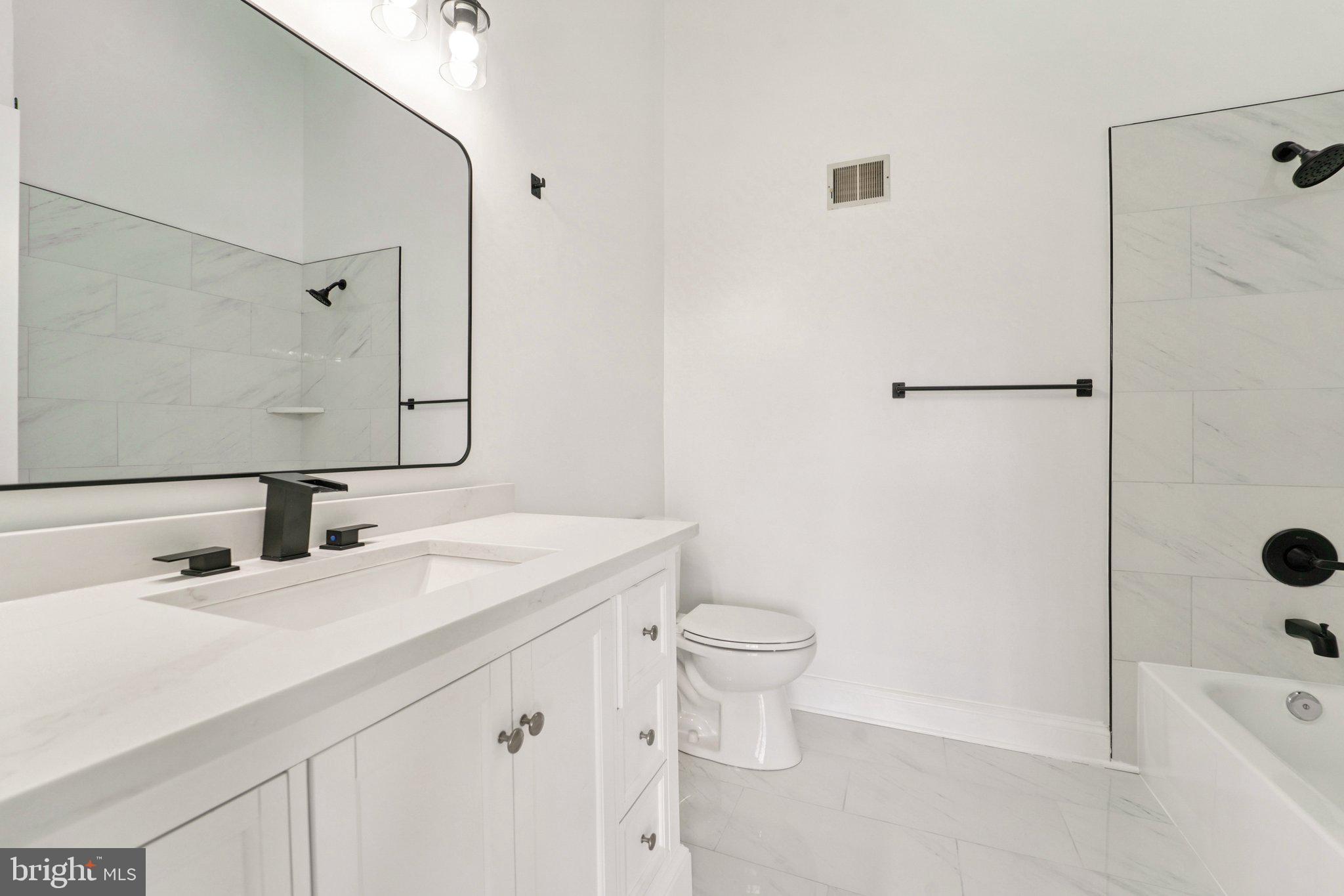 8727 Silver Hall Road Perry Hall, MD 21128 - Photo 18 of 35 a bathroom with a sink a toilet and shower