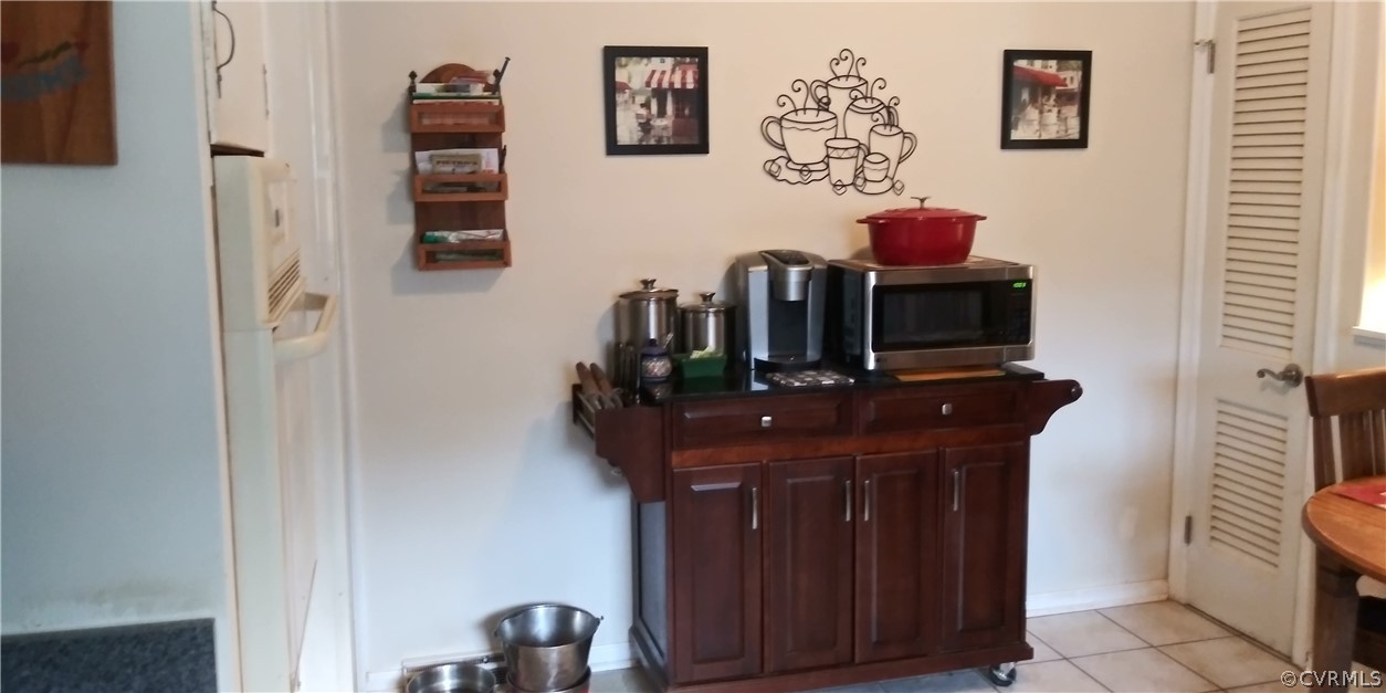 1308 Covington Road Colonial Heights, VA 23834 - Photo 6 of 15 a room with a refrigerator and a television