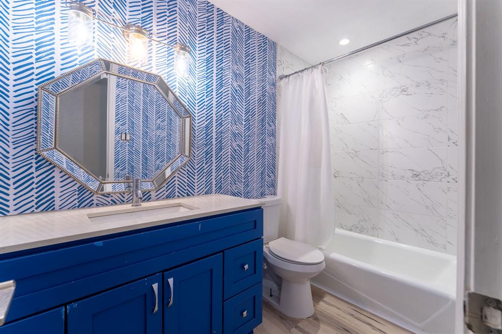 9797 Broken Bow Road Dallas, TX 75238 - Photo 12 of 16 a bathroom with a sink a toilet and shower