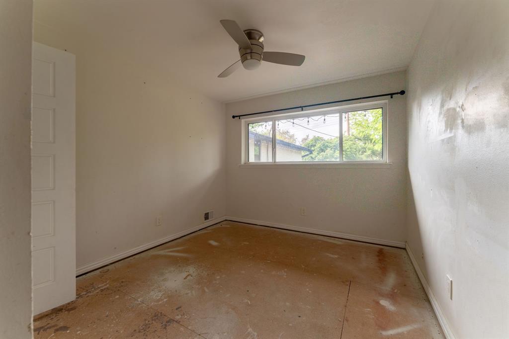 9797 Broken Bow Road Dallas, TX 75238 - Photo 13 of 16 an empty room with windows and ceiling fan