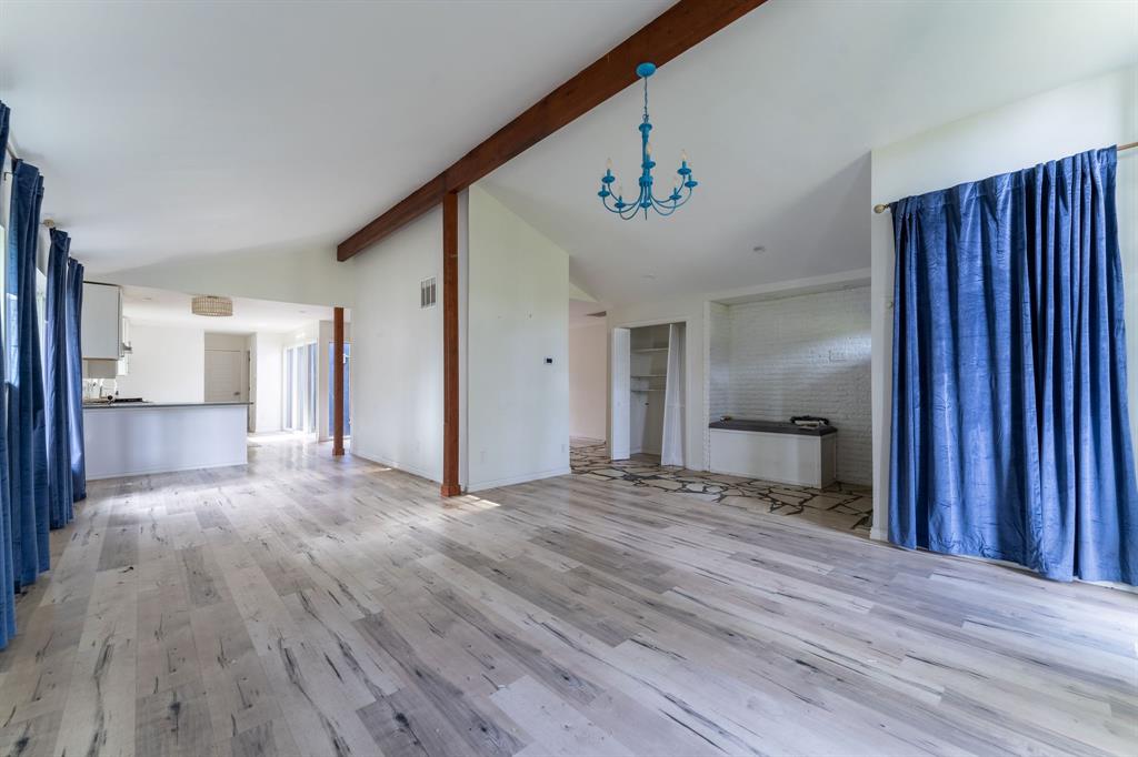 9797 Broken Bow Road Dallas, TX 75238 - Photo 5 of 16 a view of an empty room with wooden floor and a window