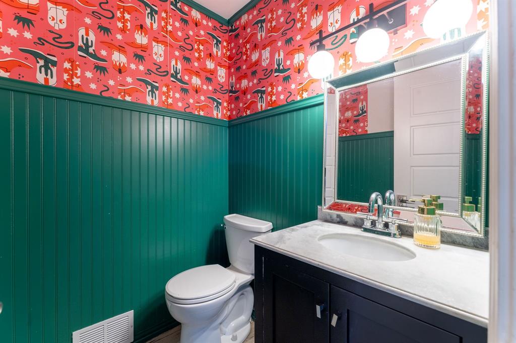 9797 Broken Bow Road Dallas, TX 75238 - Photo 7 of 16 a bathroom with a toilet sink and mirror