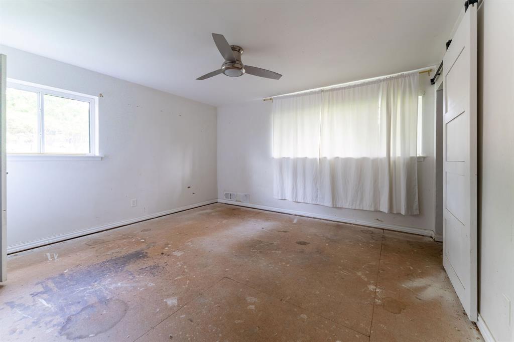 9797 Broken Bow Road Dallas, TX 75238 - Photo 10 of 16 a view of an empty room with a window