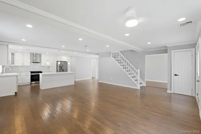 a view of an empty room and wooden floor