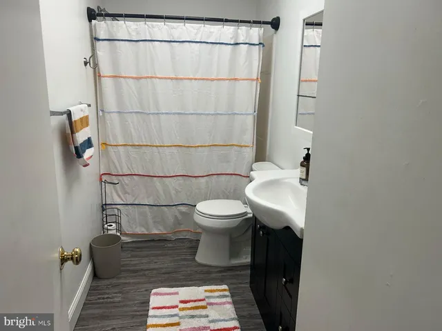 a bathroom with a toilet and a shower curtain