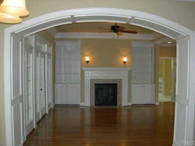 11519 Azari Court Raleigh, NC 27614 - Photo 4 of 10 a view of a livingroom with a fireplace and wooden floor