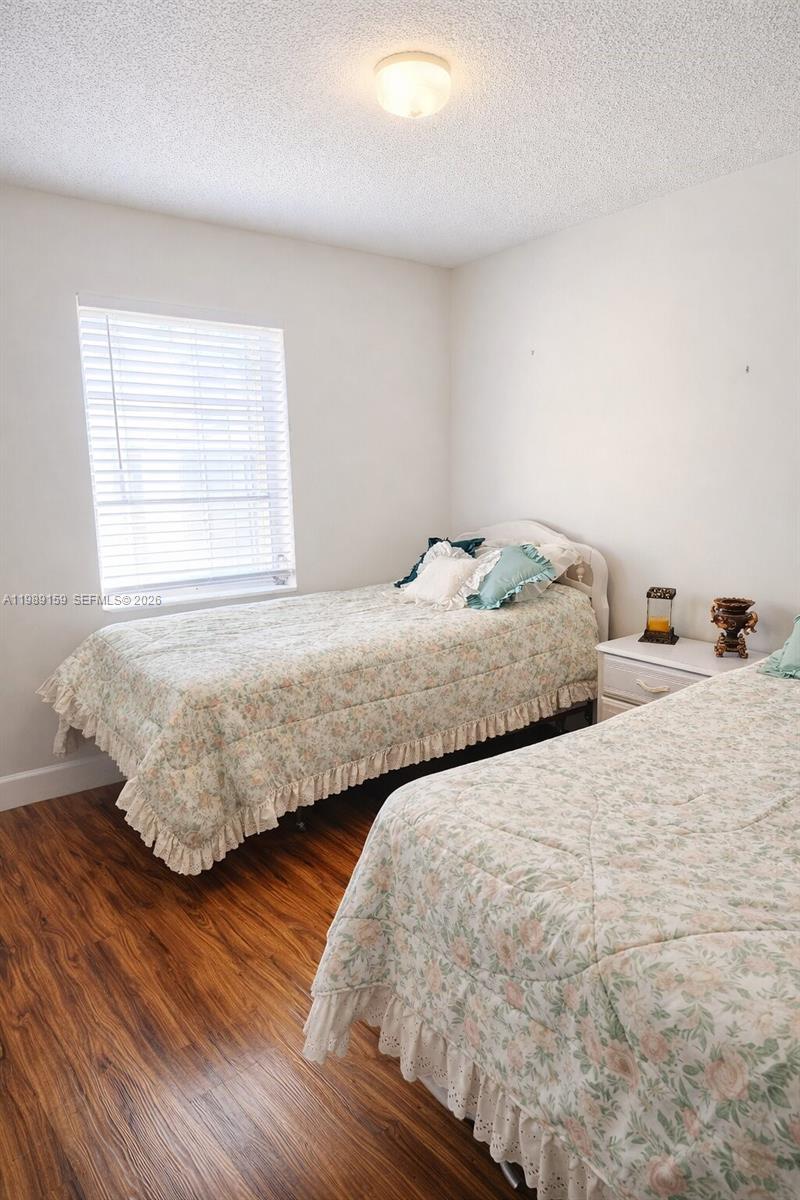 7344 Southwest 135th Court Miami, FL 33183 - Photo 14 of 24 a bedroom with two beds and wooden floor