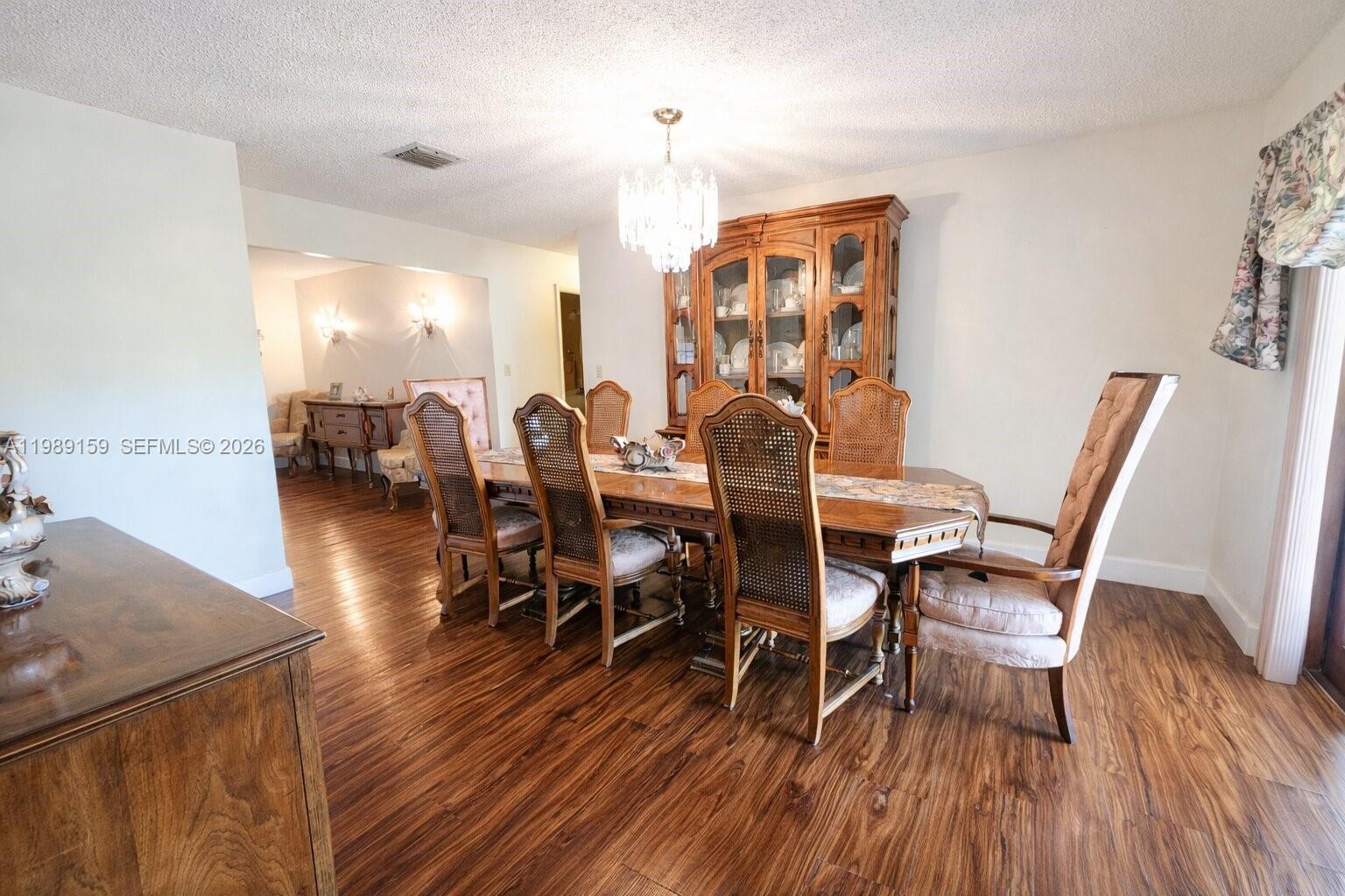 7344 Southwest 135th Court Miami, FL 33183 - Photo 6 of 24 a dining room with furniture and wooden floor