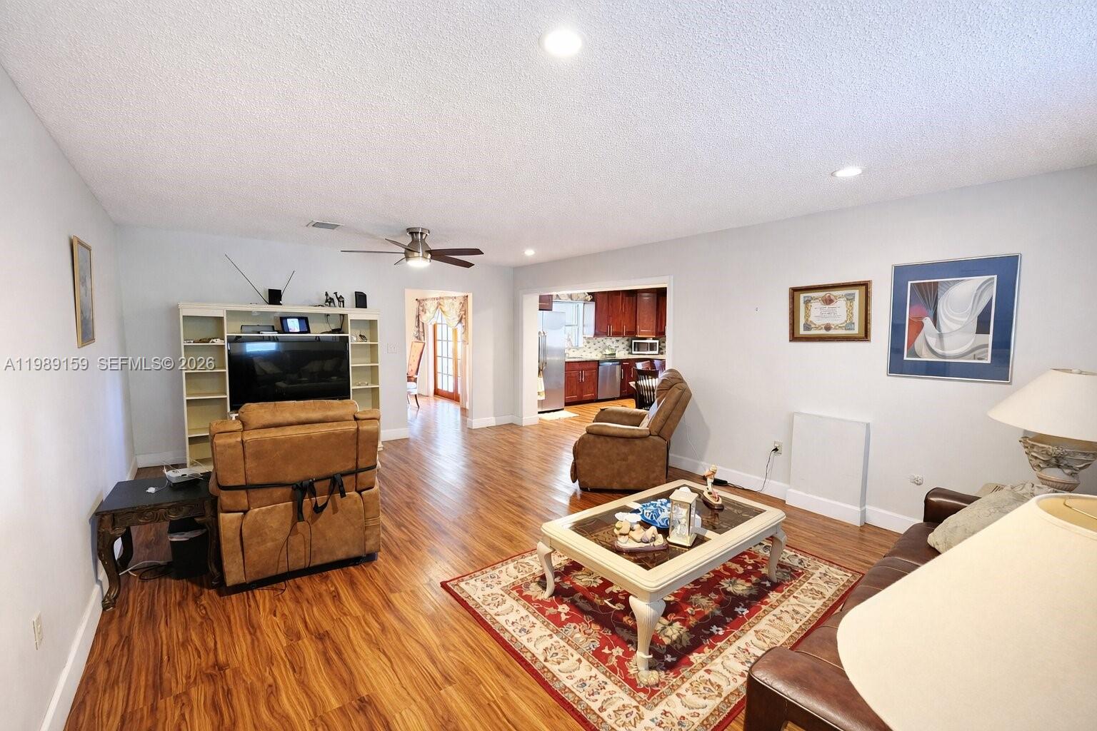 7344 Southwest 135th Court Miami, FL 33183 - Photo 7 of 24 a living room with furniture and a wooden floor