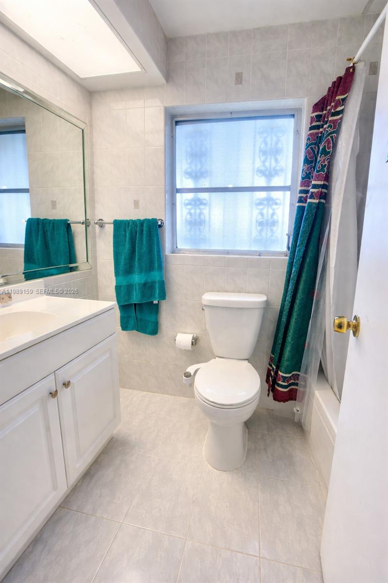 7344 Southwest 135th Court Miami, FL 33183 - Photo 10 of 24 a bathroom with a toilet a sink and a window