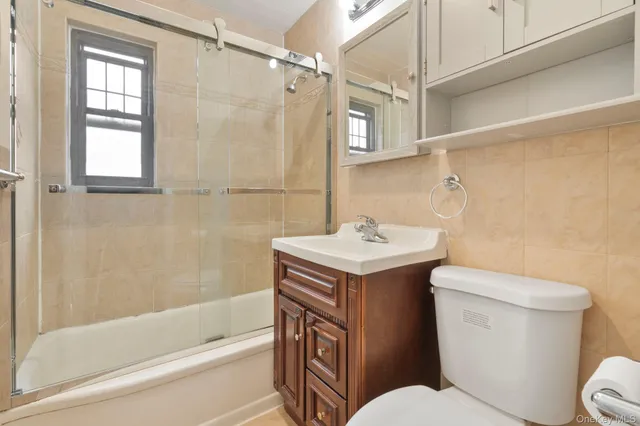 a bathroom with a sink toilet vanity and shower